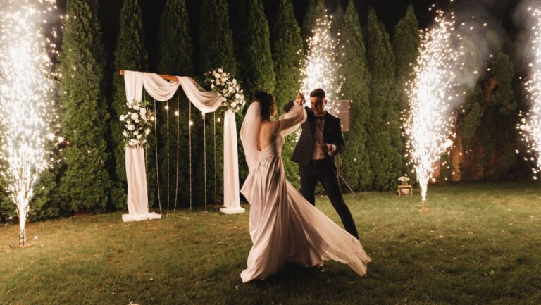 wedding couple dancing first dance with fireworks